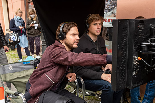 Daniel Brühl, Daniel Kehlmann (vorne v.l.n.r.) bei den Dreharbeiten zu "Nebenan" (2021); Quelle: Warner Bros. Pictures Germany, DFF, © 2021 Amusement Park Film GmbH, Warner Bros. Ent. GmbH, Reiner Bajo